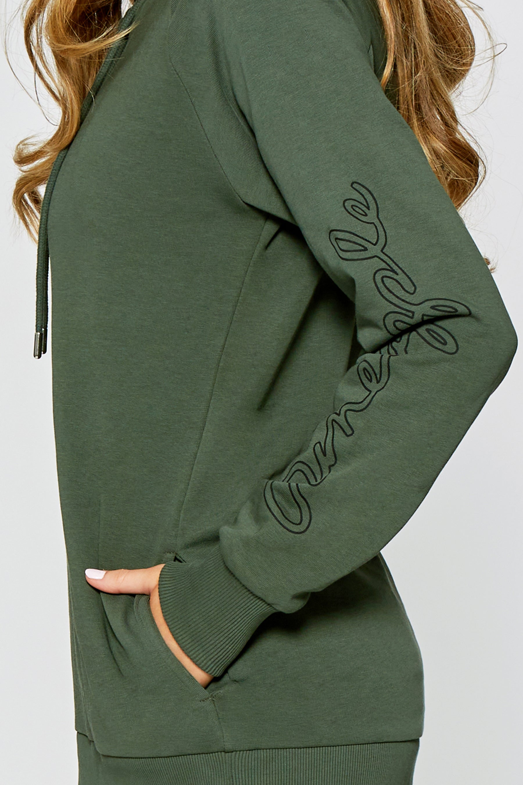 Detail shot of branding along the left sleeve f the hoodie.
